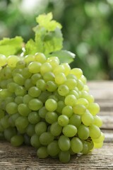 Fresh ripe grapes on wooden table, closeup