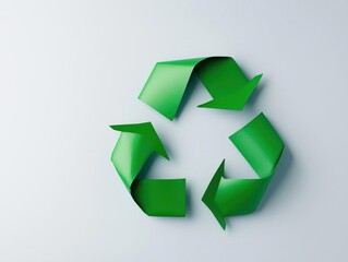 Fototapeta premium Flatlay of a minimalist green recycle symbol made from paper, surrounded by white space, eco-friendly concept