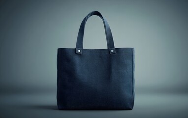 Stylish dark tote bag on a minimalist background, perfect for everyday use or shopping.