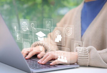 Online Education and E-Learning Concept. Person use laptop with icons representing online...