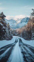 Fototapeta premium Straight Road Leading to Snowy Mountains Under Clear Blue Skies