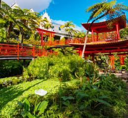 Monte Palace tropical garden with red pagoda, lakes and traditional buildings above the city of Funchal, popular tourist destination in Madeira island, Portugal