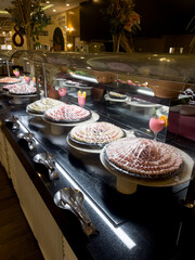 Concept of food All-inclusive buffet-style in Turkey. Place different types of sausage slices in the film. Vertical orientation. Selective focus.