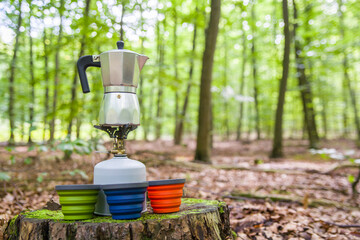 Picnic in the forest. Making coffee in the middle of the clearing.