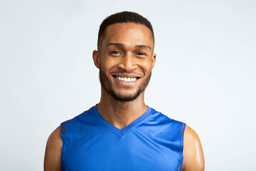 Portrait Of Happy Black Male Fitness Model Smiling At Camera Isolated Over Yellow Studio Background, Copyspace