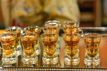 Strong alcoholic drink in small glasses.