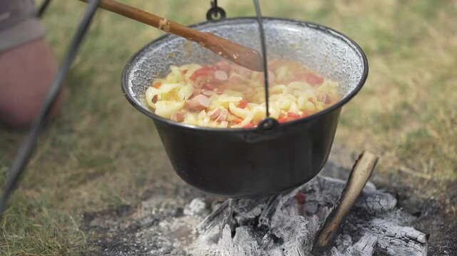 Making lecho in a cauldron outdoors