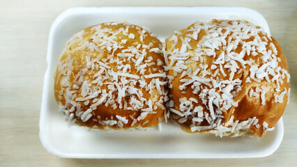 Traditional homade brazilian bread with grated coconut topping known as pão doce or sweet bread.
