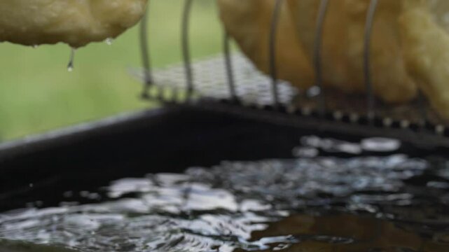 Fried flatbread (L&aacute;ngos in Hungarian language) frying in oil.