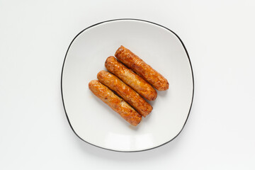 Delicious Breakfast sausages on white plate