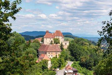 Panoramic view of historic Seggau castle on hill Seggauberg in Leibnitz, south west Styria, Austria, Europe. Idyllic landscape with trees and rolling hills. Peaceful serene atmosphere in summer © Chris