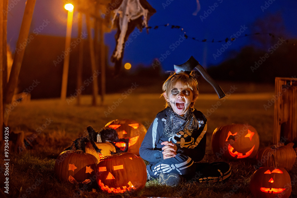 Sticker Two boys in the park with Halloween costumes, carved pumpkins with candles and decoration.