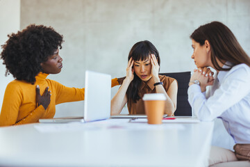 Supportive Colleagues Comforting Stressed Woman in Office Meeting
