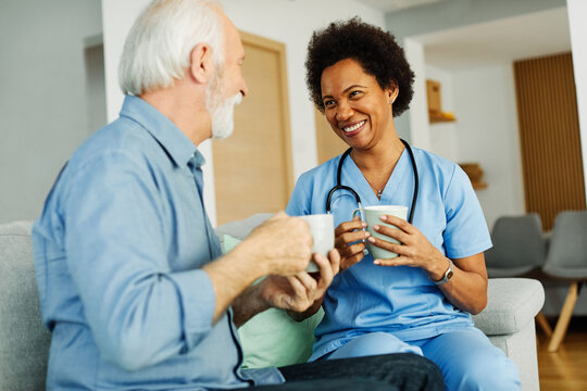 nurse doctor senior care caregiver help assistence retirement home nursing elderly woman man health support african american black coffee tea drinking cup