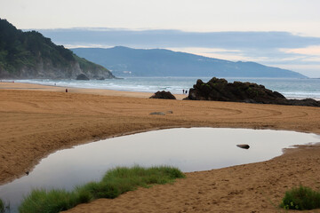 Rainy Evening at Laga Beach, Basque Country, with a Stream Flowing to the Sea