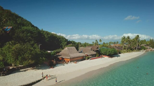 Luxury hotel huts bungalows in Bora Bora, French Polynesia. Tropical island beach lagoon tranquil escape. Perfect summer holiday, remote wild nature paradise, exotic travel. Aerial zoom out panorama