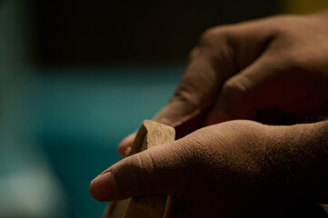 hands of a man working, closeup, wood work