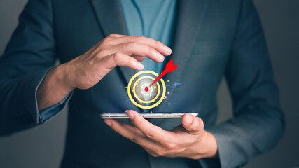 Businessman holding smart phone planning target business growth and target customer group. Marketing strategies and goals for success.