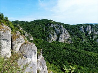 View over the Sulov Mountains in Mala Fatra. Rocky hills in coniferous trees. Hiking in Slovakia. Slovak nature. Adventurous trip in old forest. Countryside in national park. Landscape in Europe.