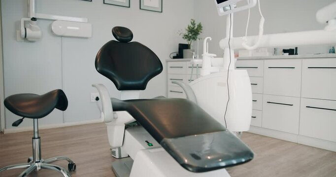 Dental, equipment and seat with teeth cleaning tools for implant, extraction or surgery at clinic. Empty, interior or dentistry of instruments, sanitary hygiene or private practice for mouth care