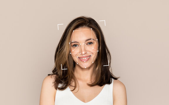 A young woman smiles while a facial recognition overlay appears around her face.