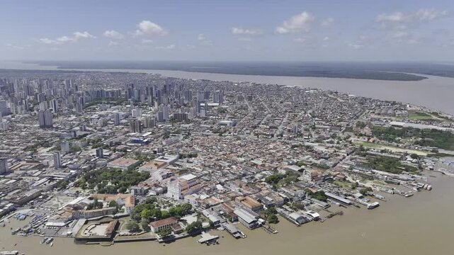 Drone flies to the left high over river, with all the city's popular tourist spots below, in Bel&eacute;m, Par&aacute;, Brazil