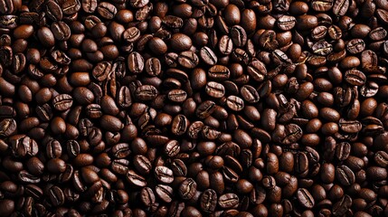 Naklejka premium Close-up of roasted coffee beans, perfect for food and beverage backgrounds.