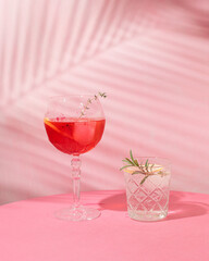 Fruit cocktails in the shade of palm branch, cold summer refreshment. Happy hour.