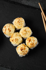 Delicious Baked Sushi Roll with Cheese Mousse Topping on Slate - Minimalist Food Photography