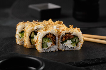 Elegant Bonito Sushi Roll with Tuna Flakes and Teriyaki Salmon in Moody Lighting on Slate Board