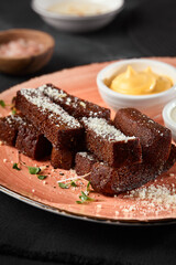 Rustic Borodinsky Garlic Croutons with Dips on Peach Ceramic Plate - Moody Lighting and Dark Background