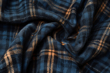 A cozy dark blue and orange flannel texture featuring a classic plaid pattern