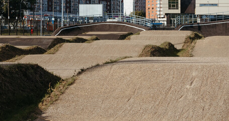 Fototapeta premium Empty BMX Race made from soil and sand. Adrenaline-Pumping Dirt BMX Race Track: A Rider's Paradise for Stunts and Speed. Extreme sport, bicycling concept