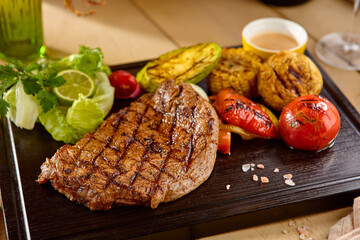 Succulent Ribeye Steak with Grilled Vegetables on Rustic Wooden Board – Vibrant Colors & High Contrast