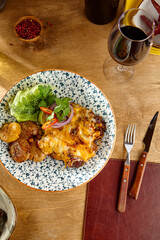 Succulent Braised Beef with Cheese and Potatoes on Elegant Rustic Setting