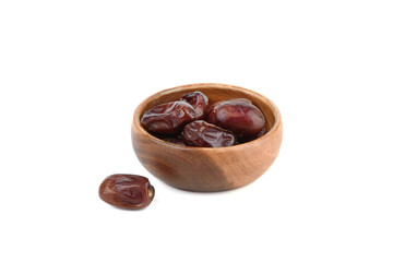 Dried fruits dates in a wooden bowl and on a white background.