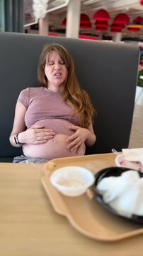 Fatty or pregnant young sad woman suffering because of overeating 