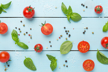 Fresh tomatoes, basil, sea salt and spices on wooden background, top view