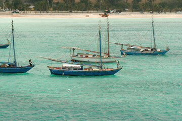 Nassau, Bahamas - April 15, 2008: Sloops are moored in the turquoise waters near the cruise port