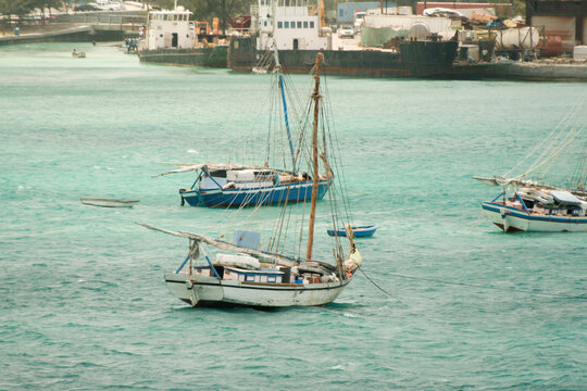 Nassau, Bahamas - April 15, 2008: Sloops are moored in the turquoise waters near the cruise port