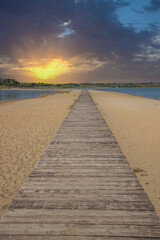 A beach surrounded by the sea on both sides. In the middle a wooden footbridge runs along the sandy beach. Natural spectacle of a Mediterranean landscape, Plaža Ždrijac, Nin, Zadar, Dalmatia, Croatia