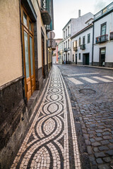 Obraz premium A view of a decorative pavement in Ponta Delgada on the island of San Miguel in the Azores in summertime
