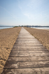 A beach surrounded by the sea on both sides. In the middle a wooden footbridge runs along the sandy beach. Natural spectacle of a Mediterranean landscape, Plaža Ždrijac, Nin, Zadar, Dalmatia, Croatia