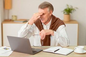 Eyestrain In Old Age. Senior Man Massaging Aching Eyes Holding Eyeglasses Working On Laptop...