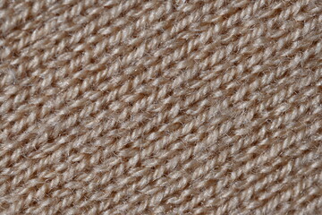 texture of knitted light brown sweater, close-up texture of beige knitted fabric, macro texture of tan knitted woolen clothes