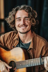 Obraz premium A person with long curly hair holding and playing a guitar, possibly in a casual or musical setting