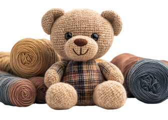 a stuffed bear next to several rolls of yarn


