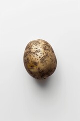 Fototapeta premium A single potato sits alone on a wooden table
