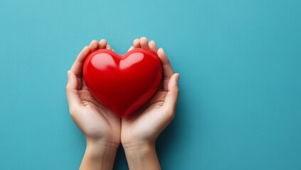 Fototapeta premium hands hold a red heart on a blue background. 