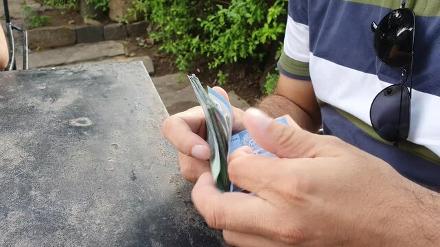 A businessman counting Malaysian Ringgit by hands. A paper currency counting manually. 